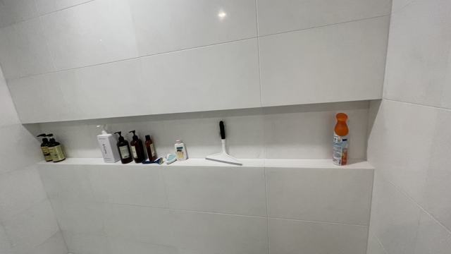 Recessed shower niche in light tile