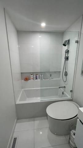 Tiled shower enclosure and toilet from another viewpoint