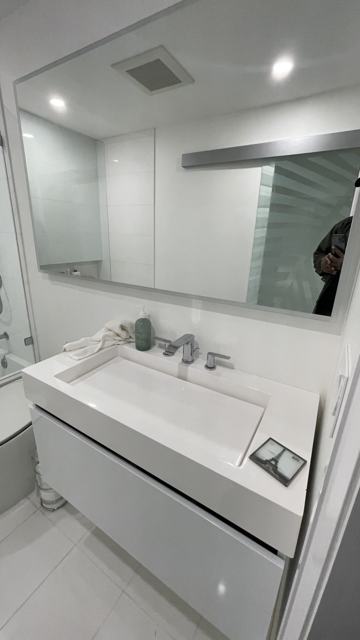 White bathroom vanity and mirror