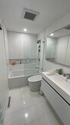 Bathroom vanity and glass shower enclosure from another viewpoint