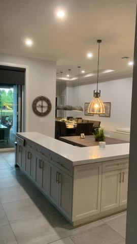 Kitchen island and pendant lighting, viewed from the hallway