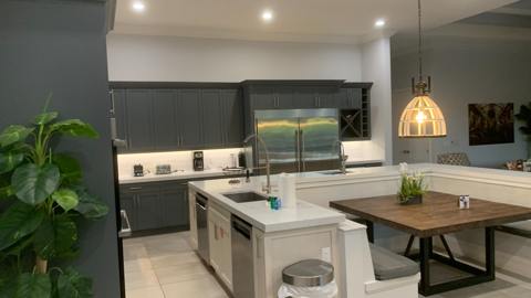 Kitchen island with seating, pendant lighting and stainless appliances