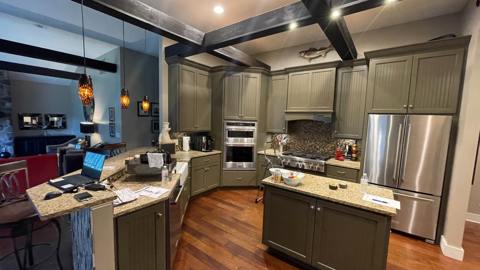 Kitchen with stainless appliances, wood cabinetry and overhead storage