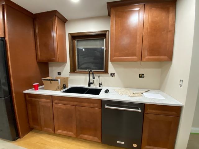 Kitchen with warm wood cabinetry and contrasting countertops