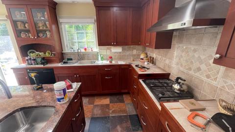 Kitchen work in progress with wood cabinetry and materials on site
